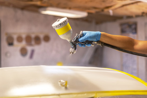 Worker Painting A White Car