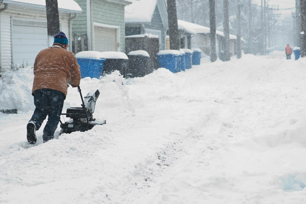 Man Is Cleaning Alley Before Harsh snow