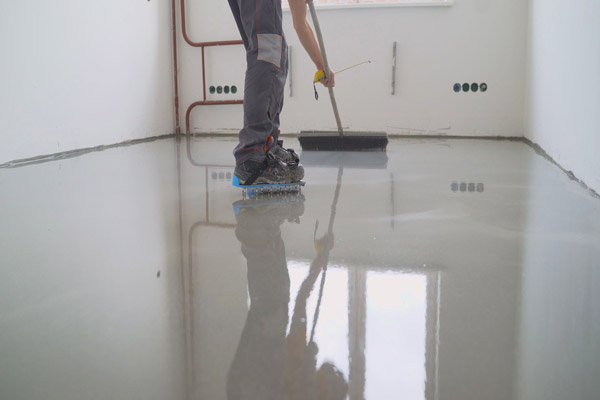 Master With A Needle Roller For Epoxy Flooring