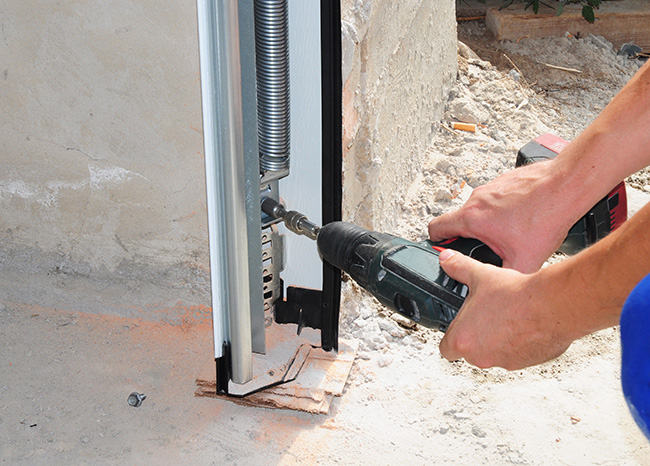 professional drywalling a garage and installing a garage door