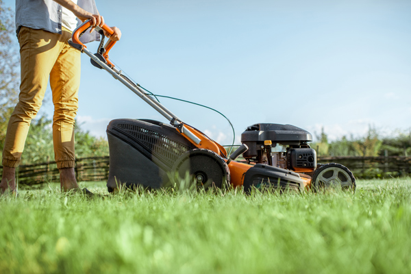 Man Cutting Grass With Gasoline