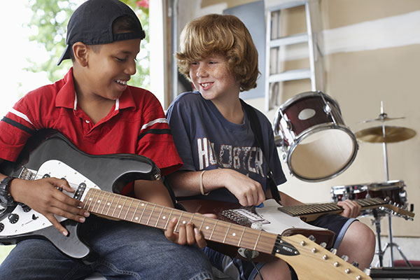 kids playing guitar in a soundproof garage