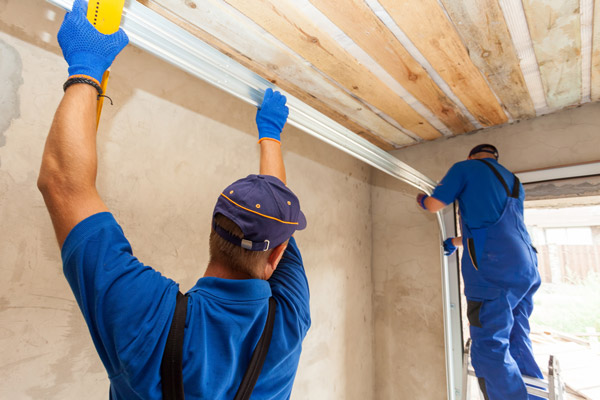 technicians troubleshooting faulty garage door