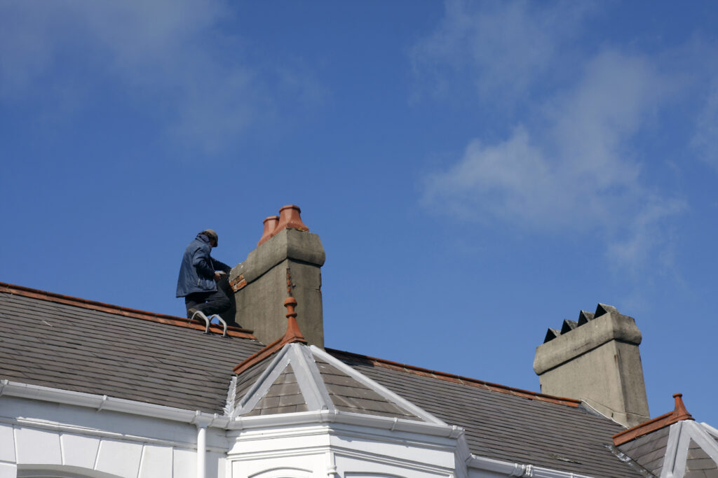 Workman Repairing A Chimney